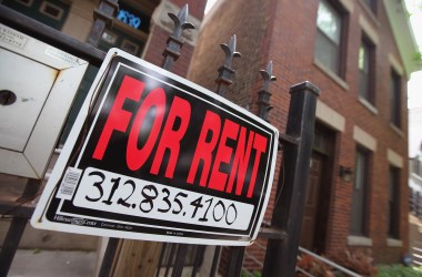 A For Rent sign stands in front of a house on in Chicago, Illinois.