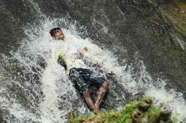 An Indian boy cools off in a waterfall during a hot summer day at the Basistha area in Guwahati, India, on June 13th, 2019. India is experiencing one of the longest and most intense heat waves in decades. Temperatures as high as 123 degrees have been recorded. The heat wave has led to at least 36 deaths since it began last month.