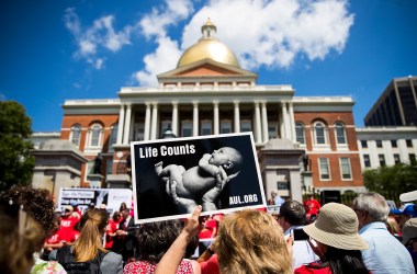 Supporters of Massachusetts Citizens for Life hold signs during a rally outside the Massachusetts Statehouse on June 17th, 2019, in Boston, Massachusetts. Opposing activists were rallying in advance of consideration by lawmakers of measures aimed at loosening restrictions on abortion.