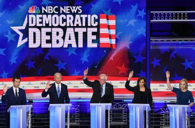 Pete Buttigieg, Joe Biden, Bernie Sanders, Kamala Harris, and Kirsten Gillibrand participate raise their hands in the second Democratic primary debate.