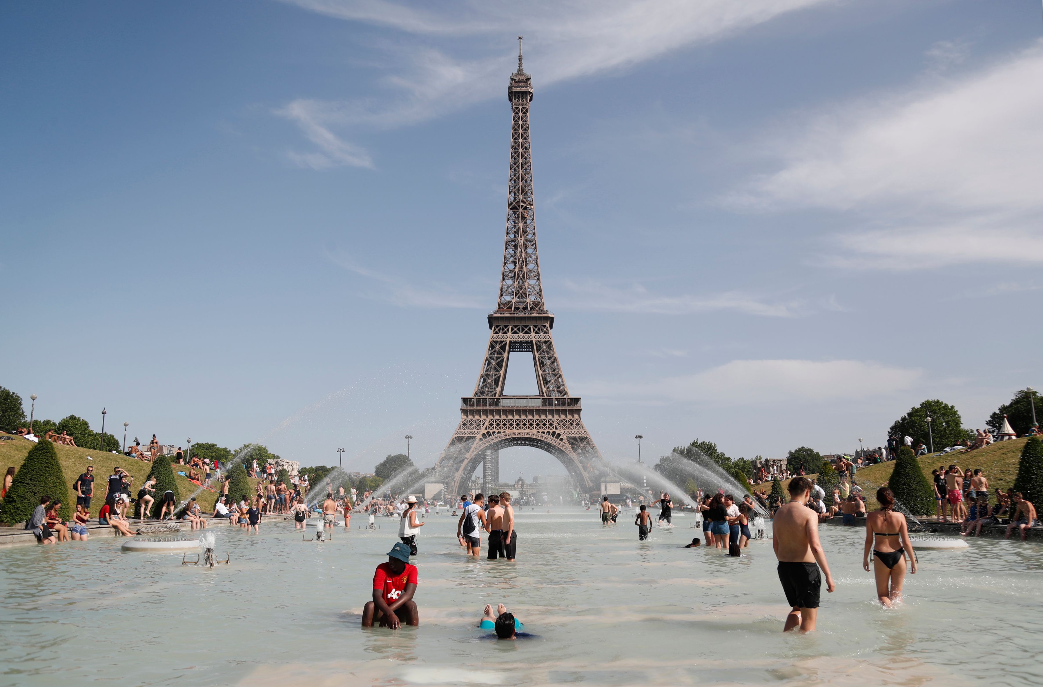 People bathe in the Trocadero Fountain in front of the Eiffel Tower in Paris during a heat wave on June 28th, 2019. The temperature in France on June 28th surpassed 45 degrees Celsius (113 degrees Fahrenheit) for the first time as Europe wilted in a major heat wave, state weather forecaster Meteo-France said.