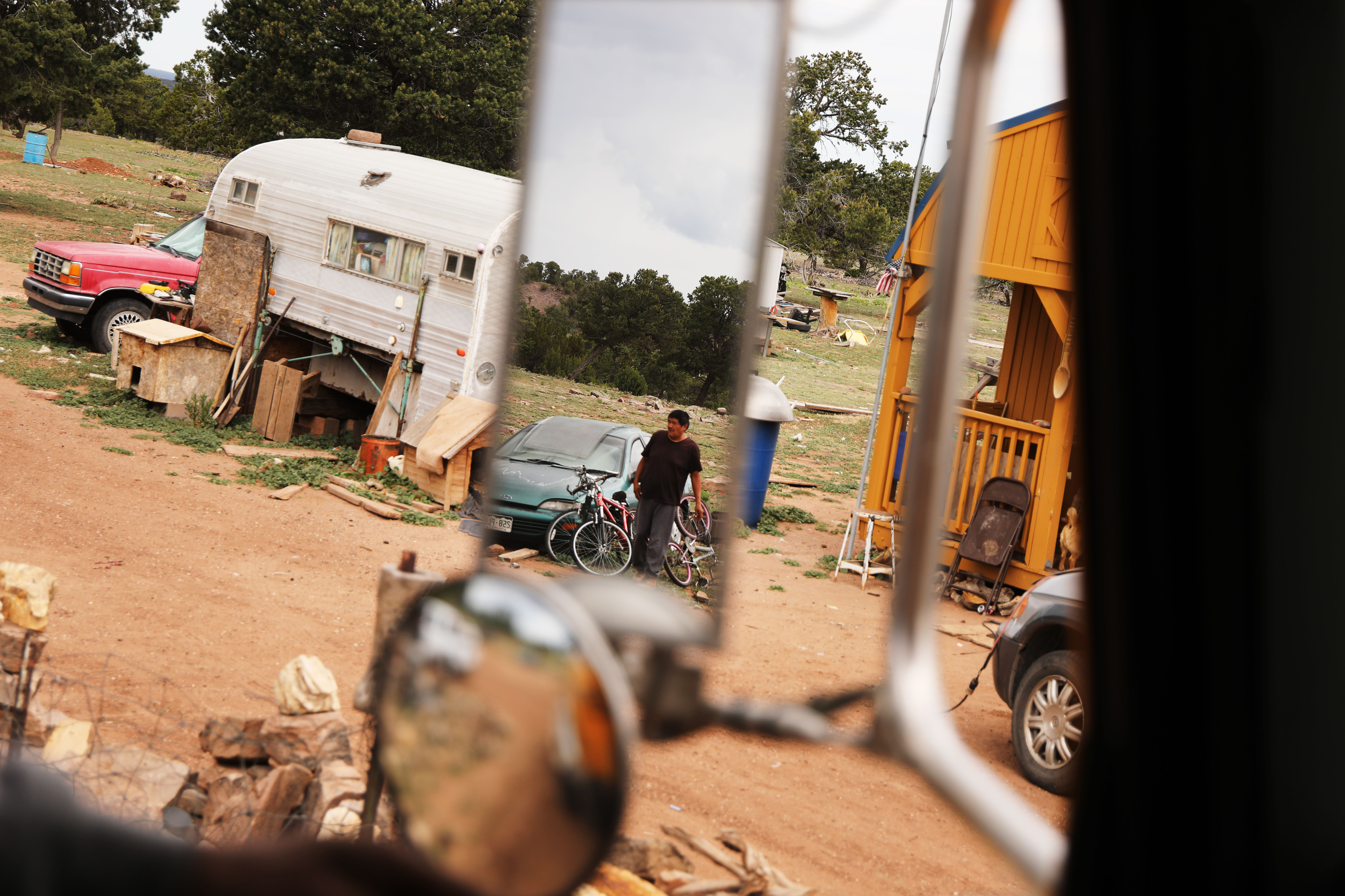 A man fills a water tank on June 5th, 2019, in Thoreau, New Mexico.