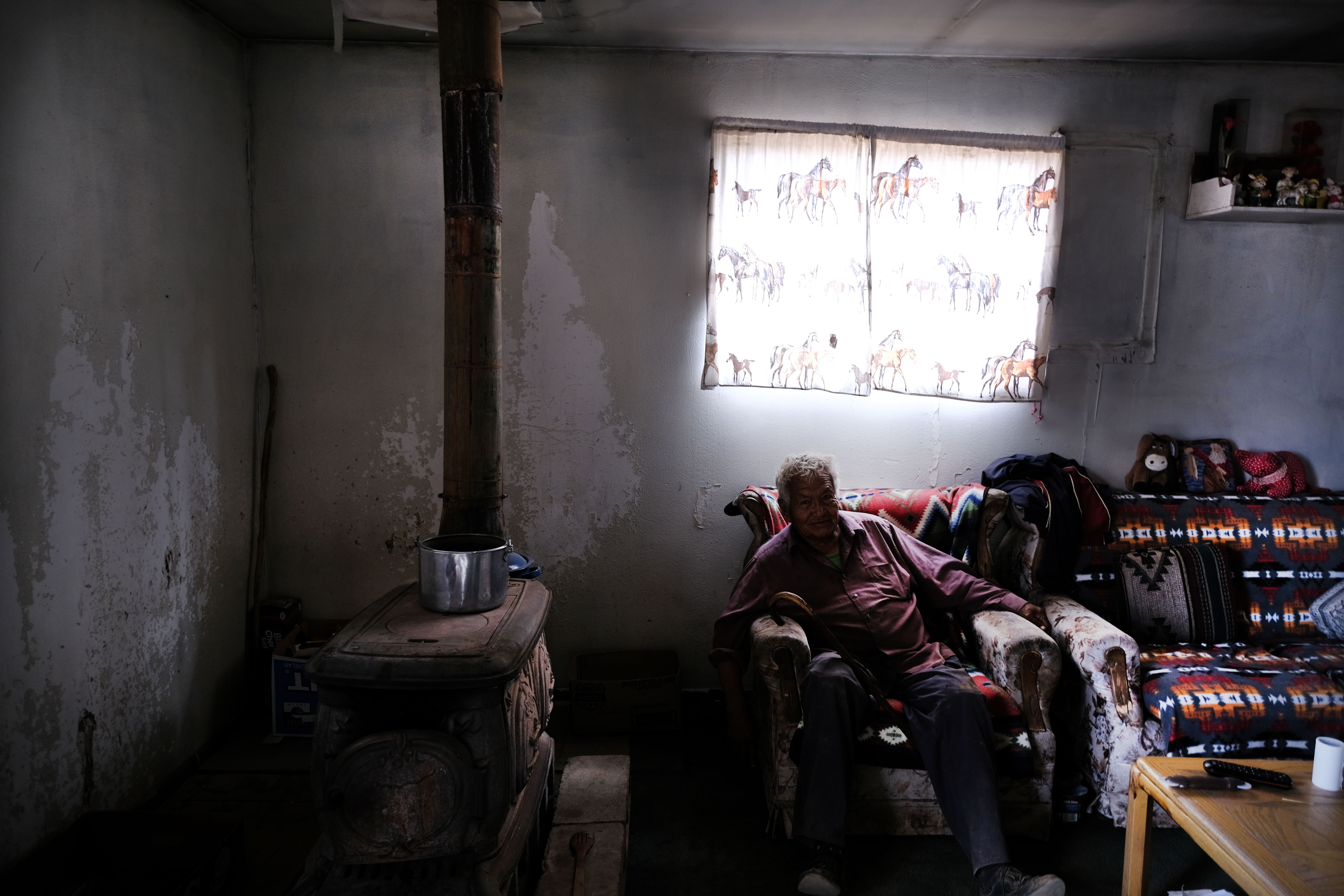 An elderly member of the Navajo Nation waits in his home for his monthly water delivery in the town of Thoreau on June 6th, 2019.