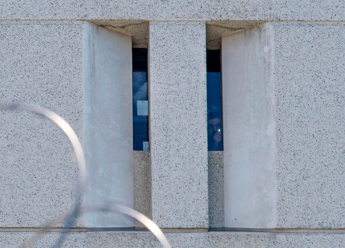 Two prisoners from earlier round-ups look out from a cell window at the main ICE detention center in downtown Los Angeles on July 14th, 2019.