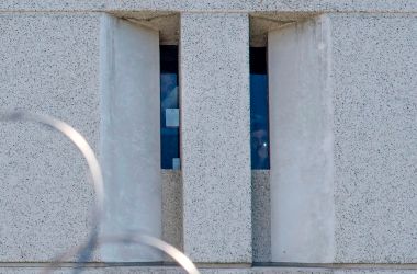 Two prisoners from earlier round-ups look out from a cell window at the main ICE detention center in downtown Los Angeles on July 14th, 2019.