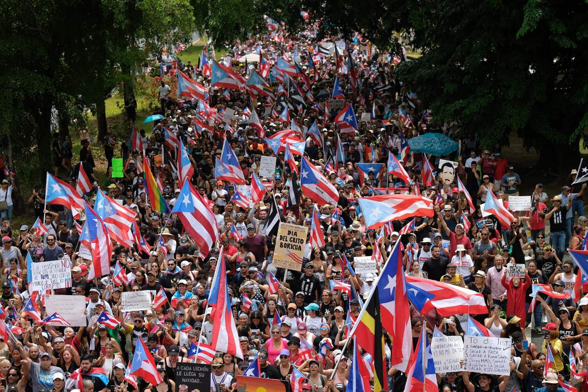 People march in San Juan on July 25th, 2019, one day after the Puerto Rico Governor Ricardo Rossello announced his resignation.