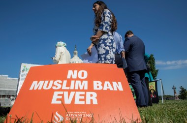 Activists protest on the anniversary of the Supreme Court's ruling upholding the Trump administration's restriction of travel to the U.S. from predominantly Muslim countries.