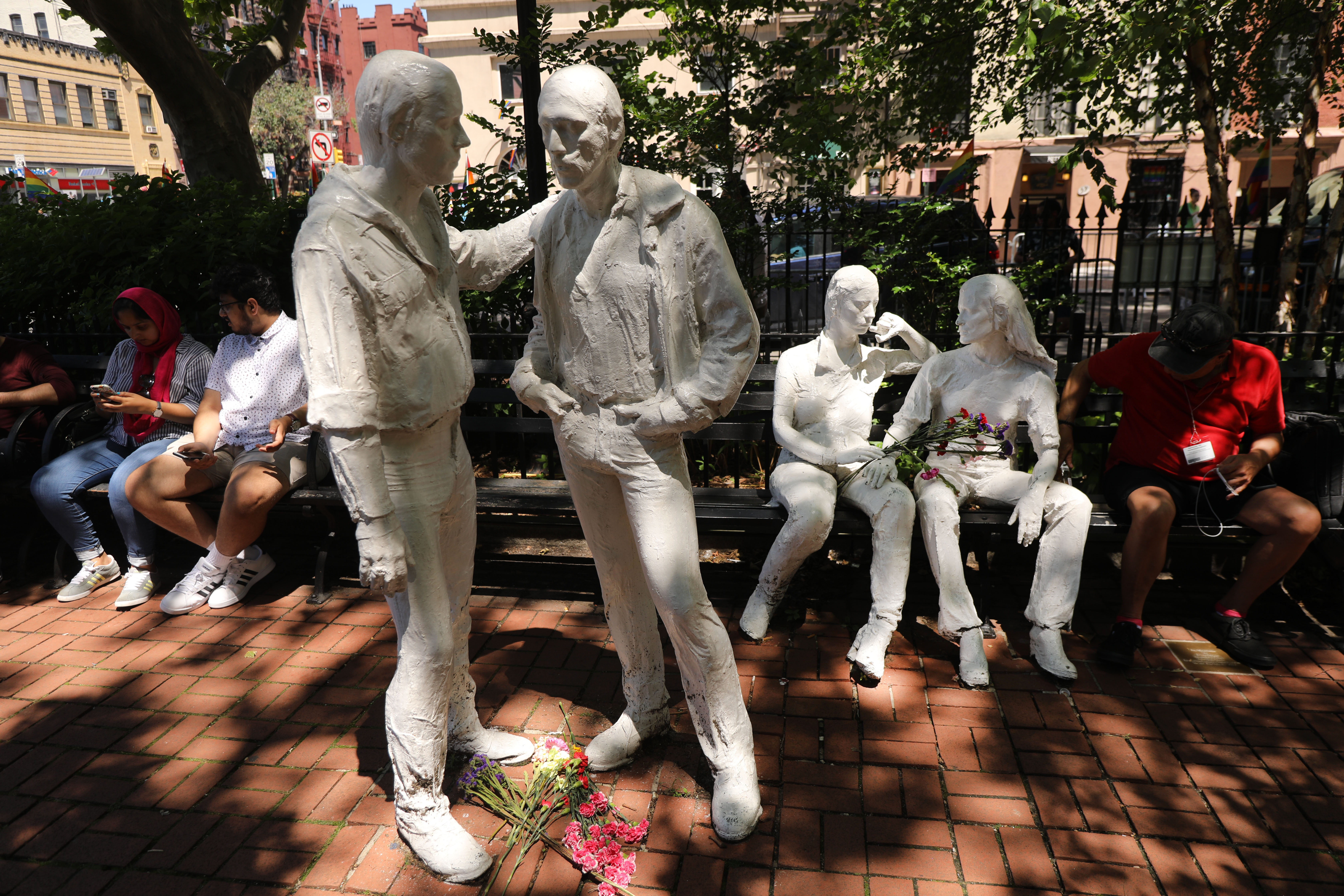 Statues celebrating gay life in New York City stand outside the Stonewall Inn as a crowd gathers to celebrate Pride Month on June 26th, 2019, in New York City.