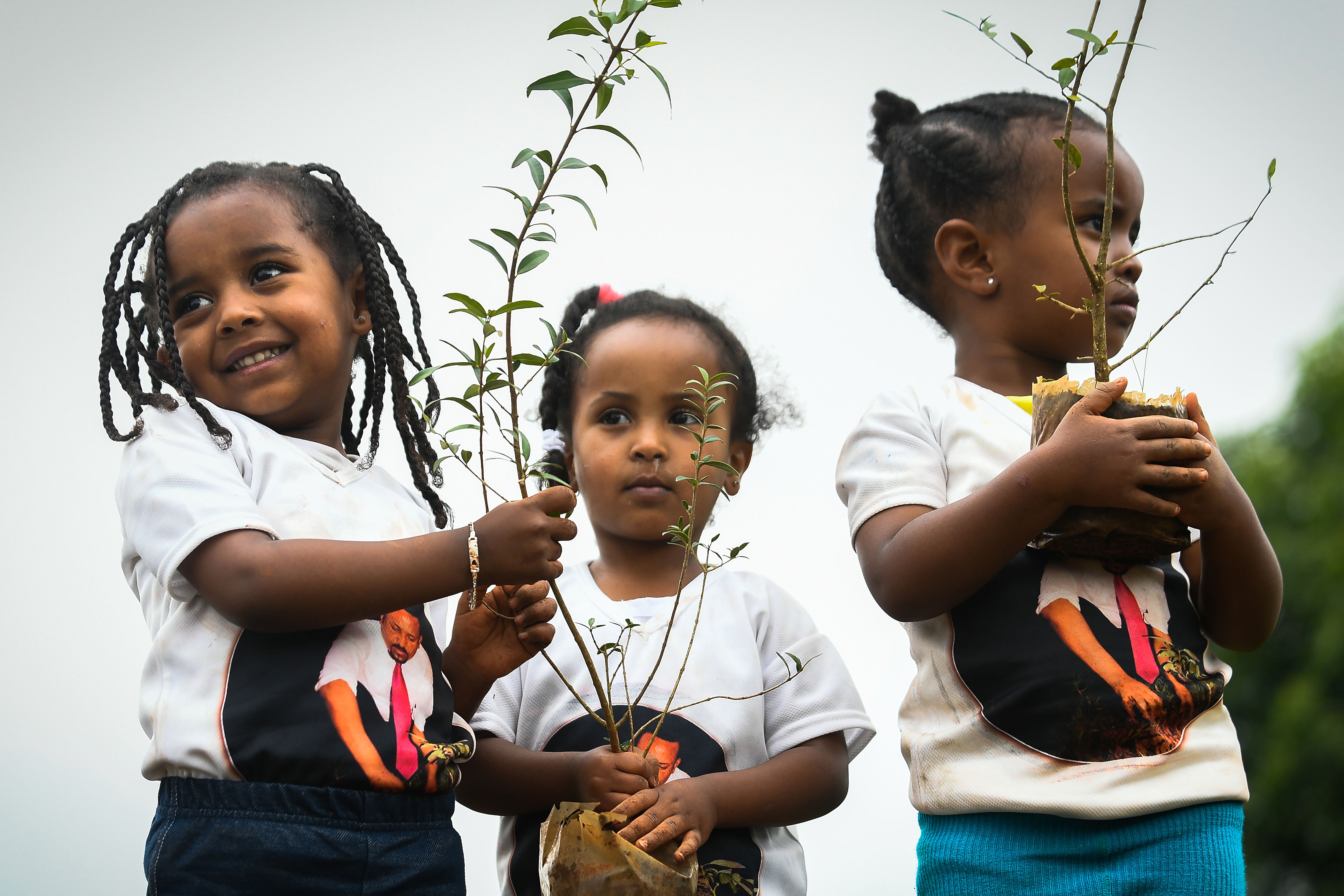 Ethiopian girls wear T-shirts depicting Ethiopia's Prime Minister Abiy Ahmed as they take part in a national tree-planting drive in the capital of Addis Ababa, on July 28th, 2019. The Green Legacy campaign, started by Ahmed's office, wants every Ethiopian to plant 40 seedlings during the rainy season, which runs from May to October.