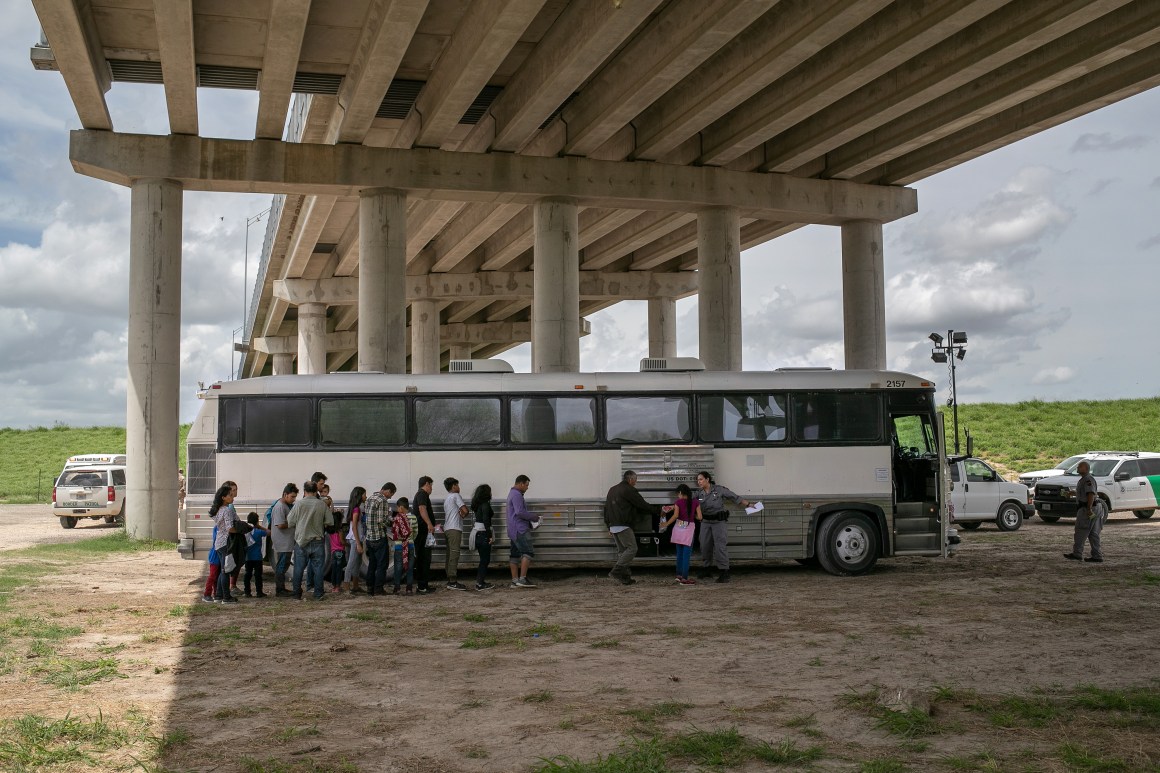 Immigrants wait to be transported to a U.S. Border Patrol processing center after they were taken into custody on July 2nd, 2019, in McAllen, Texas. The immigrants, mostly families from Central America, turned themselves in to border agents after rafting across the Rio Grande from Mexico to seek political asylum in the United States.