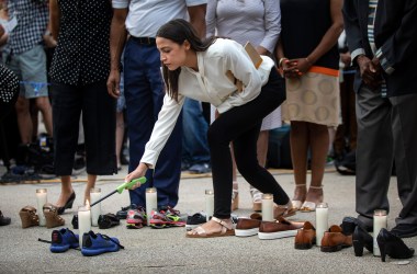 Representative Alexandria Ocasio-Cortez (D-New York) lights a candle during a vigil for the victims of the recent mass shootings in El Paso, Texas, and Dayton, Ohio, in Grand Army Plaza on August 5th, 2019, in Brooklyn. Lawmakers and local advocates called on Congress to enact gun control legislation and encouraged citizens to vote for politicians who would support those measures.