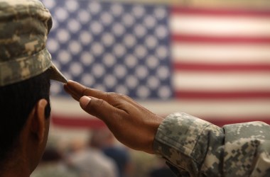 A soldier salutes the flag.