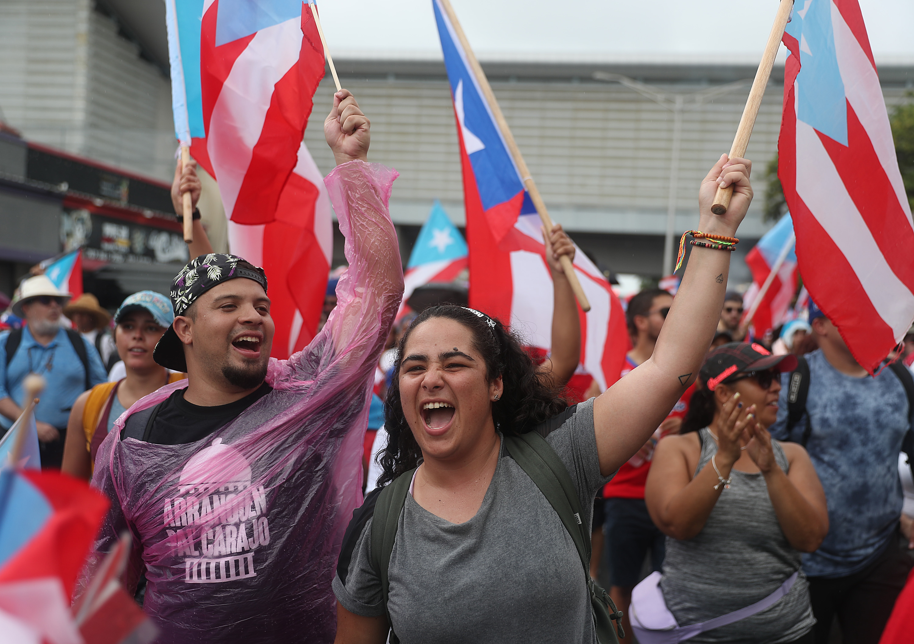 People march through the financial district as they celebrate the ousting of Ricardo Rosselló in Old San Juan, Puerto Rico.