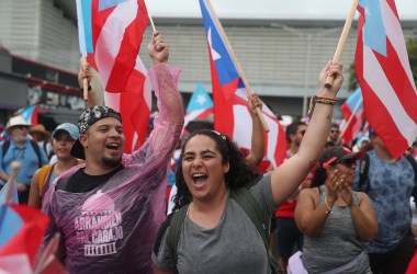 People march through the financial district as they celebrate the ousting of Ricardo Rosselló in Old San Juan, Puerto Rico.