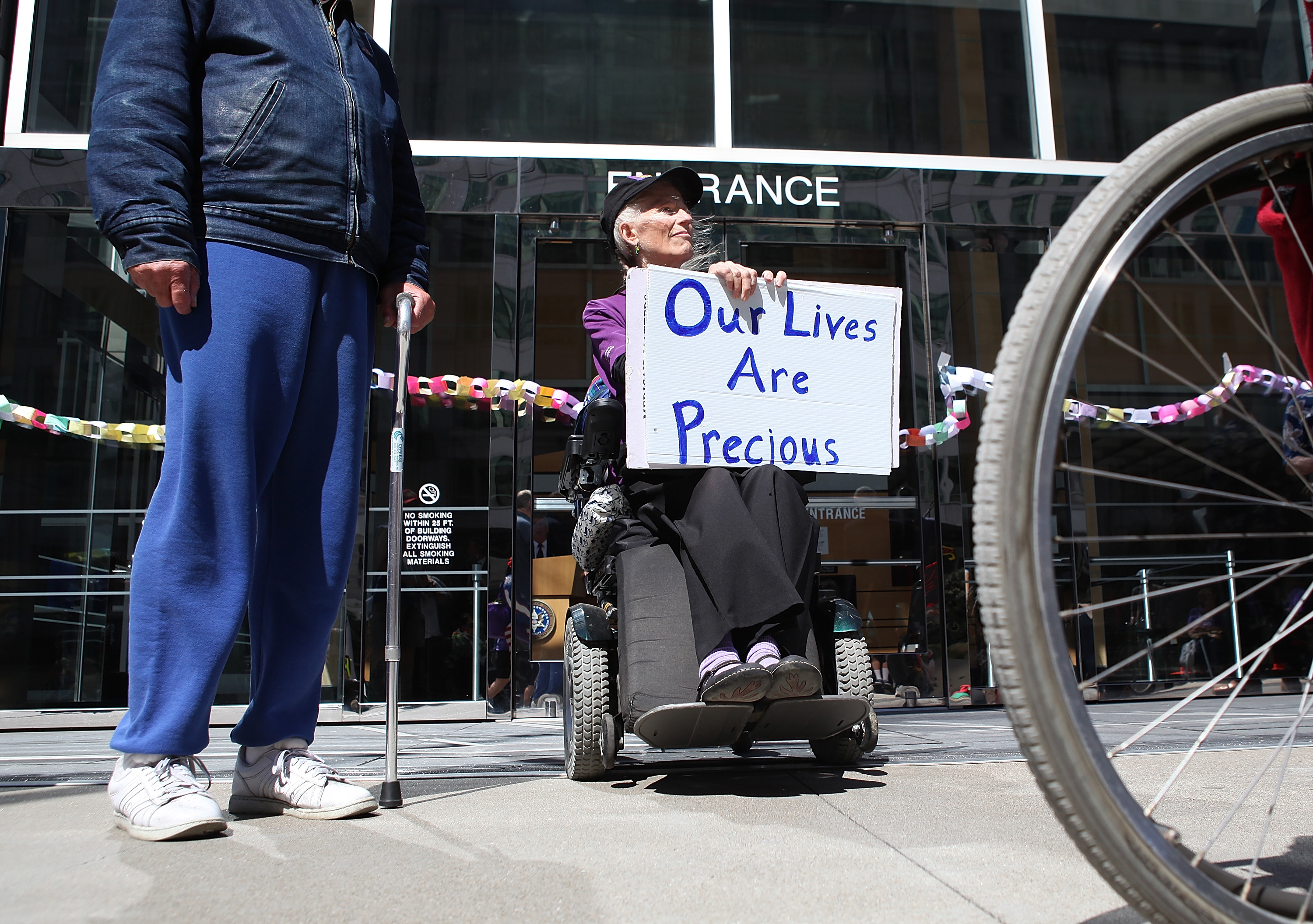 Disabled people carry signs as they protest cuts to Medicare on September 21st, 2011, in San Francisco, California.