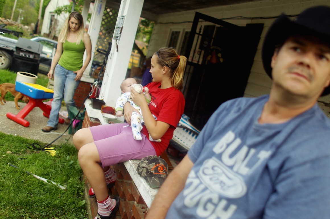 A family spends time on their porch in Booneville, Kentucky.