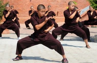 Buddhist nuns practice kung fu at the Amitabha Drukpa Nunnery on the outskirts of Kathmandu, Nepal.