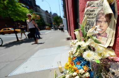 People walk past a street shrine to six-year-old Etan Patz, who disappeared 33 years ago, set in front of the building where suspect Pedro Hernandez confessed to having strangled the boy in New York.