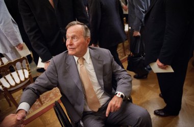 Former President George H.W. Bush shakes hands as he departs from the East Room of the White House following the official portrait unveiling of his son, former President George W. Bush, on May 31st, 2012, in Washington, D.C.