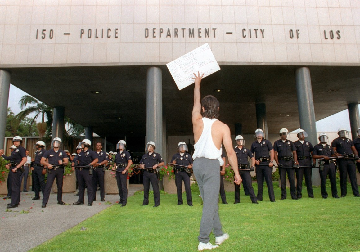 A demonstrator protests the verdict in the trial of four Los Angeles police officers accused of beating motorist Rodney King outside the Los Angeles Police Department headquarters in Los Angeles on April 29th, 1992.