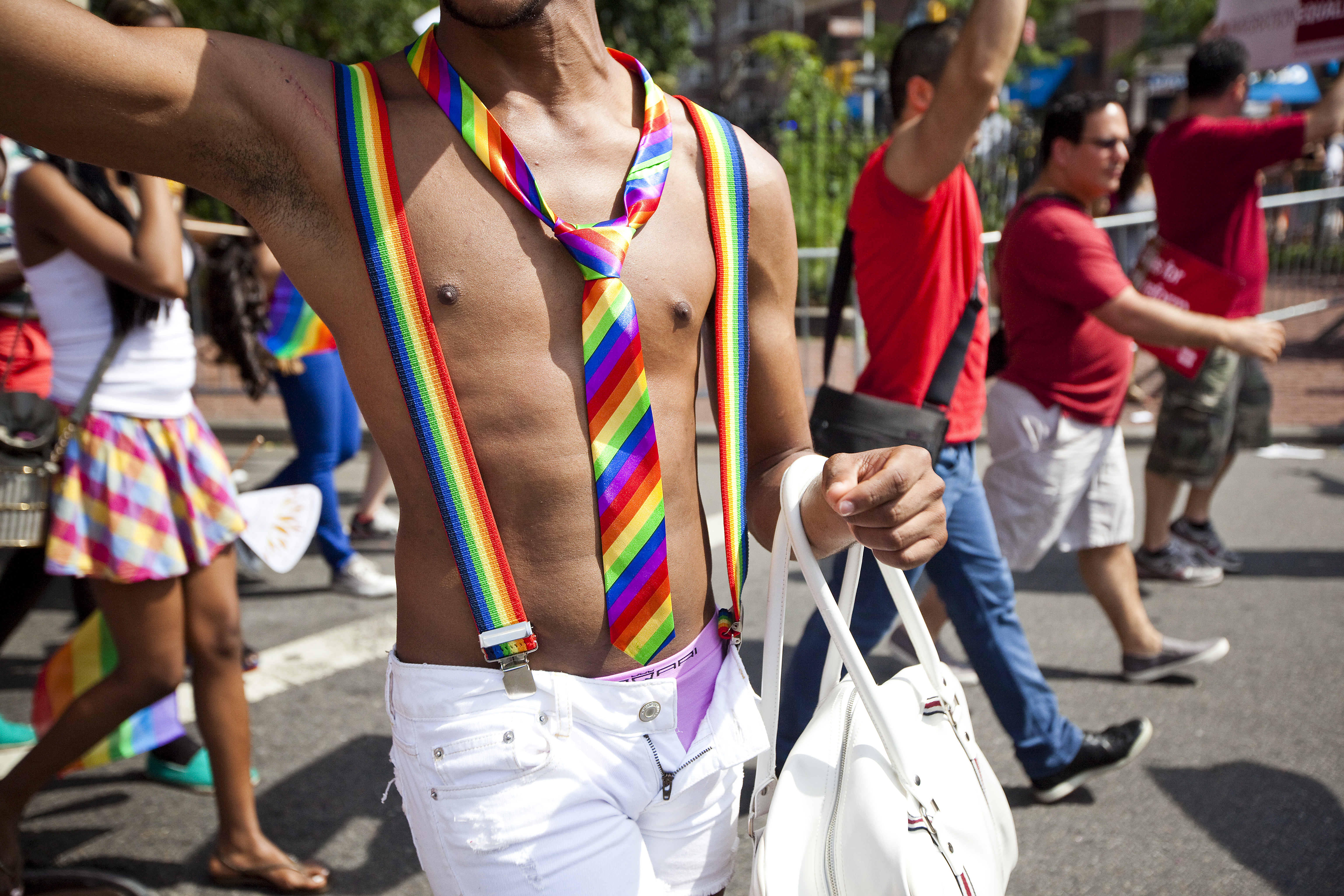 A man wears matching rainbow suspenders and tie during the Gay Pride March on June 24th, 2012, in New York City.