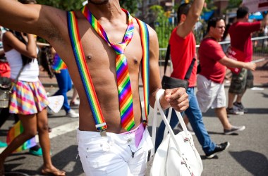 A man wears matching rainbow suspenders and tie during the Gay Pride March on June 24th, 2012, in New York City.