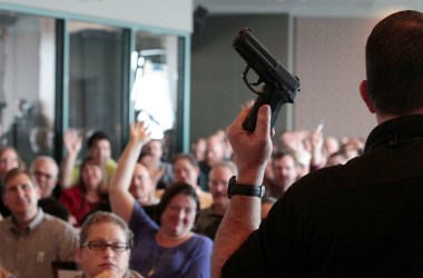 Firearm instructor Clark Aposhian holds a handgun up as he teaches a concealed-weapons training class to 200 Utah teachers in December of 2012. After the Marjory Stoneman Douglas High School shooting in Parkland, Florida, 14 state legislatures introduced bills calling to arm school staffs.