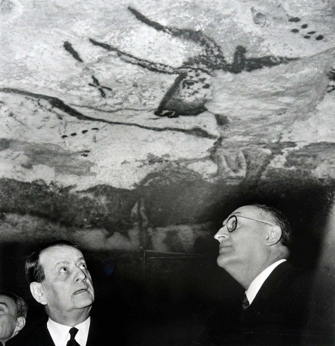 French Minister for Culture Andre Malraux (L) looks at the prehistoric paintings during his visits at the Lascaux caves, on March 13th, 1967.