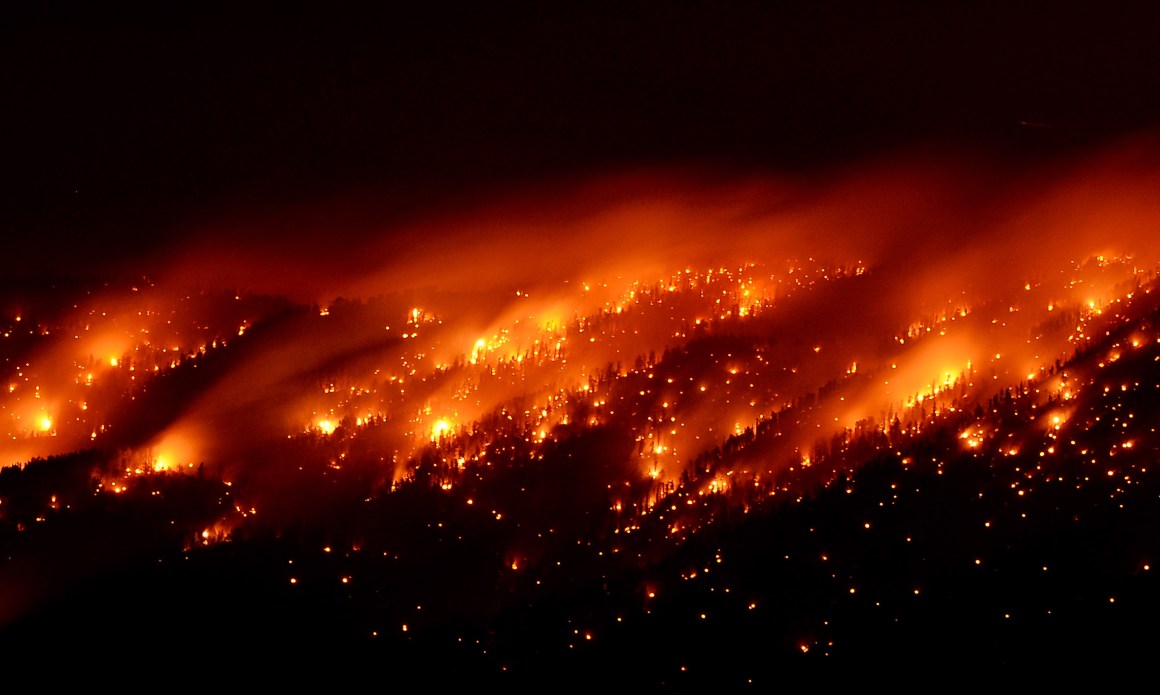 Smoke and flames from the Carpenter 1 fire are seen along a ridgeline in the Spring Mountains range early on July 6th, 2013, in the Spring Mountains National Recreation Area, Nevada.