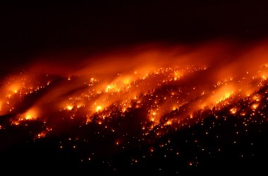 Smoke and flames from the Carpenter 1 fire are seen along a ridgeline in the Spring Mountains range early on July 6th, 2013, in the Spring Mountains National Recreation Area, Nevada.