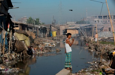 Dhaka, Bangladesh: Momin Mohammad, a leather worker, brushes his teeth by a canal near his home in the city's polluted Hazaribagh neighborhood. Each day, tanneries dump 22,000 liters of toxic waste into the Buriganga, the capital city's main river and key water supply.