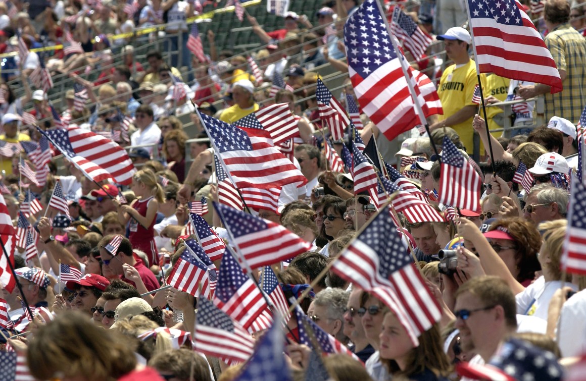 Supporters wave U.S. flags as they attend the Rally for America event at Marshall University stadium on May 24th, 2003, in Huntington, West Virginia.