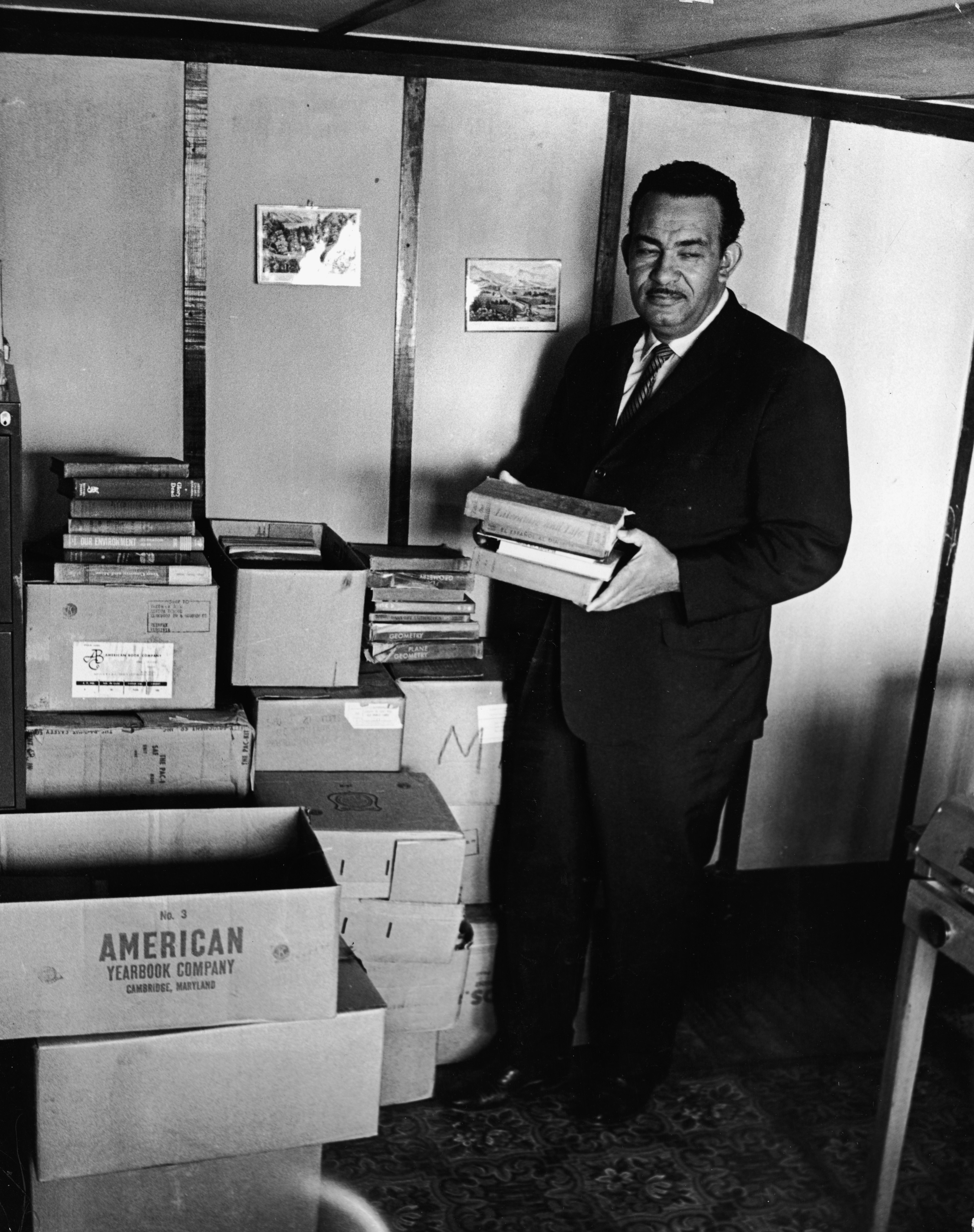 Civil rights activist Reverend Francis Griffin holds school books donated for the private schooling of black children, circa 1959. Prince Edward County, Virginia, shut down its public school system to avoid having to desegregate.