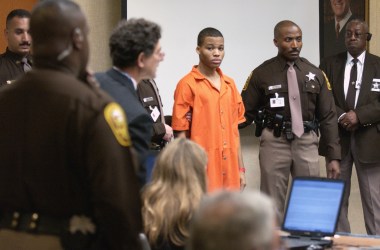 Sniper suspect Lee Boyd Malvo (center) is escorted by deputies as he is brought into court to be identified by a witness during the murder trial in courtroom 10 at the Virginia Beach Circuit Court on October 22nd, 2003, in Virginia Beach, Virginia.