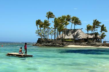 Melanesian children float on a bamboo pontoon by Wicked Walu Island on the resort-studded Coral Coast of Fiji, November 11th, 2003. Since the Bali bombings 12 October 2002 tourism has overtaken sugar cane as the South Pacific archipelago's primary source of foreign revenue.