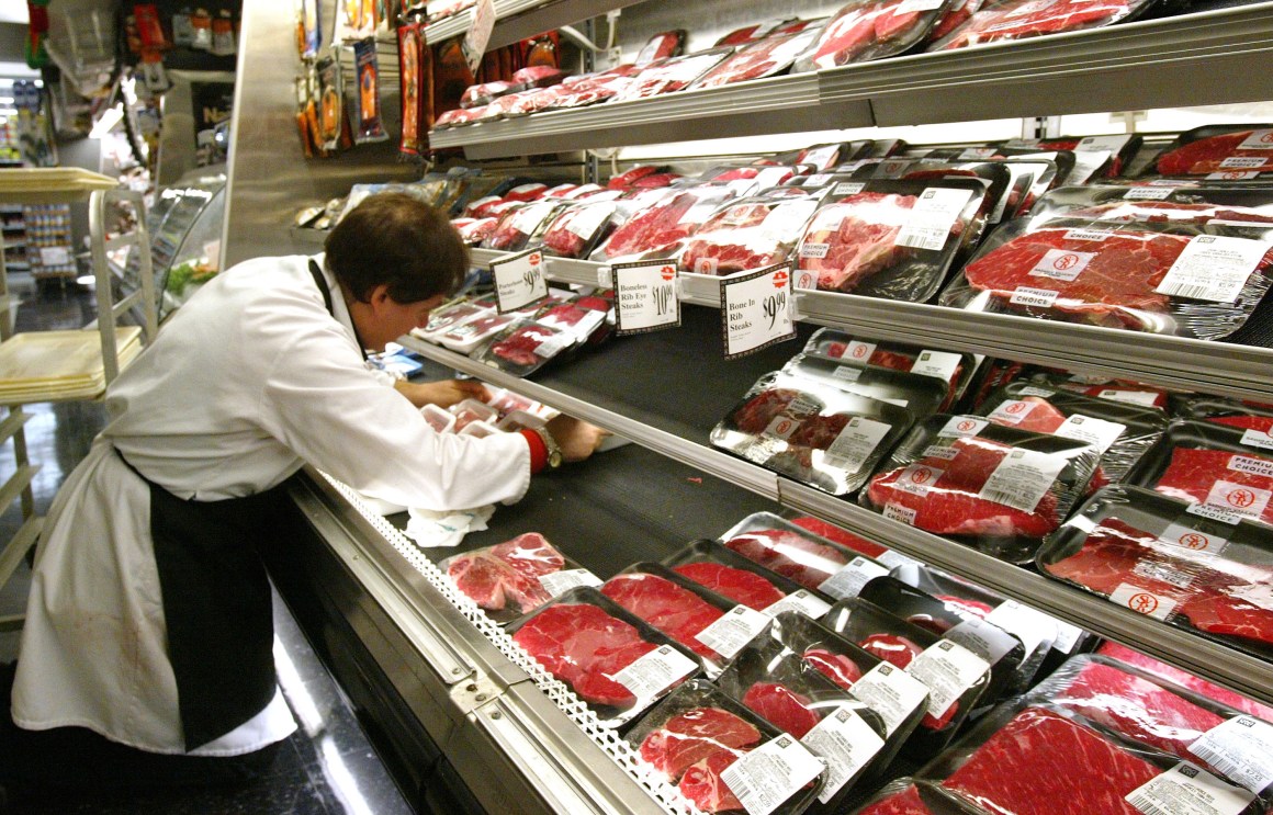 A butcher arranges meat products at a grocery December 29th, 2003, in New York City.