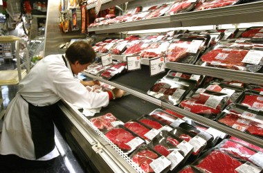 A butcher arranges meat products at a grocery December 29th, 2003, in New York City.