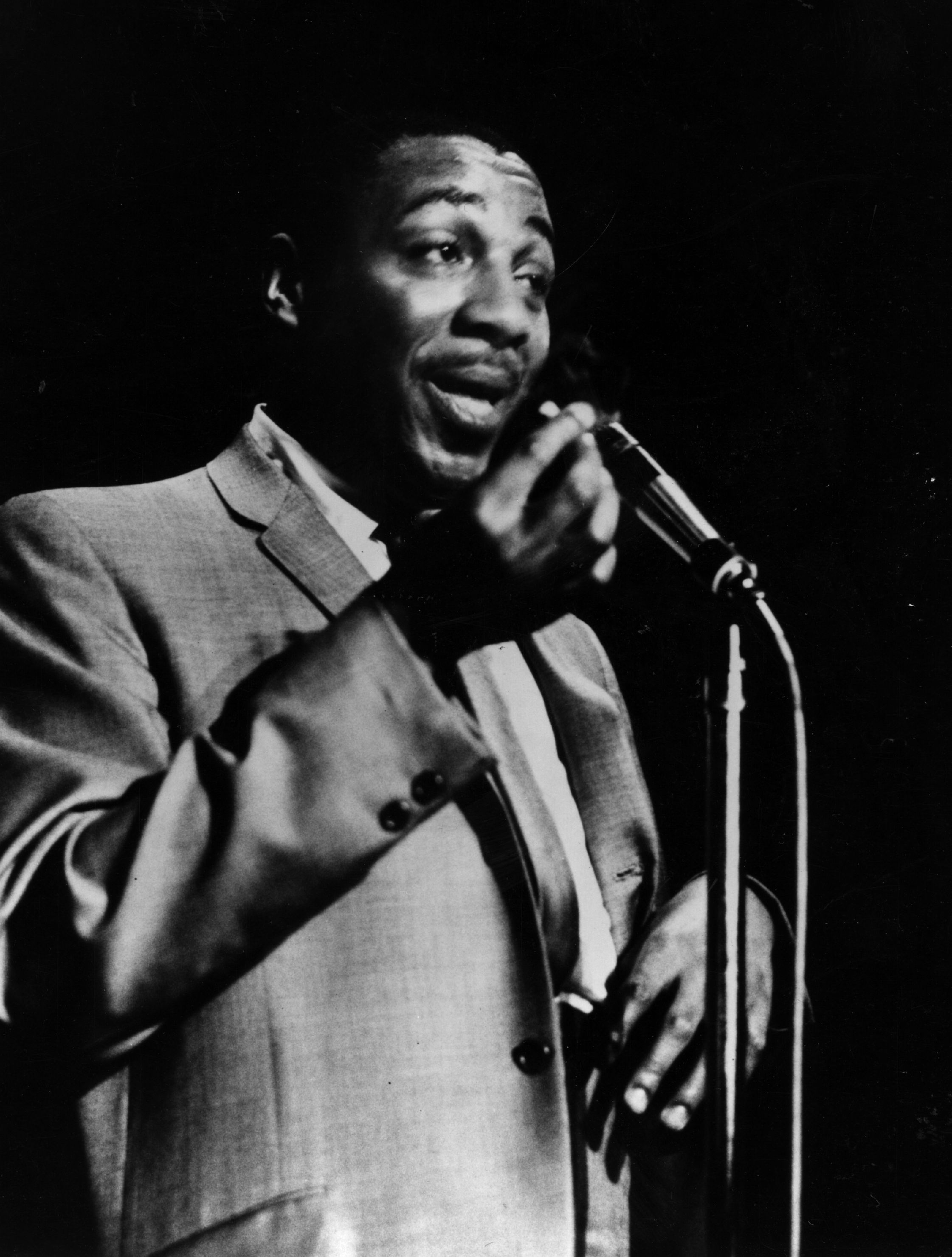 Dick Gregory at the microphone in 1962.