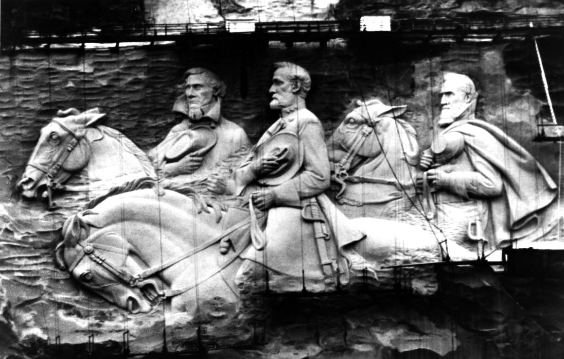 Giant figures sculptured in granite rock on Stone Mountain in Atlanta, Georgia. The figures represent Jefferson Davis, the only president of the Confederate States of America with Confederate Generals Robert E Lee and Stonewall Jackson.