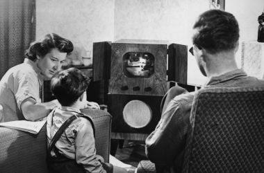 A family watching television at home, circa 1955.