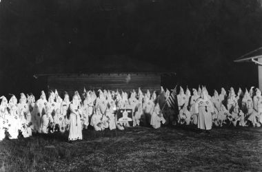 A meeting of hooded members of the Ku Klux Klan circa 1920.