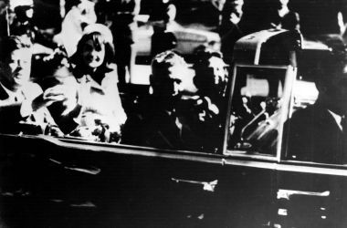 President John F. Kennedy and his wife Jacqueline ride with secret agents in an open car motorcade shortly before the president was assassinated in Dallas, Texas, on November 22nd, 1963.