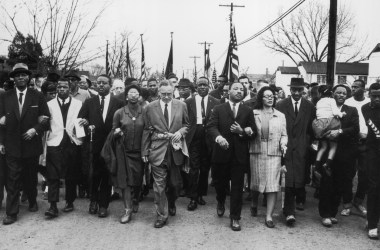 Martin Luther King and Coretta Scott King lead a civil rights march in Selma, Alabama.