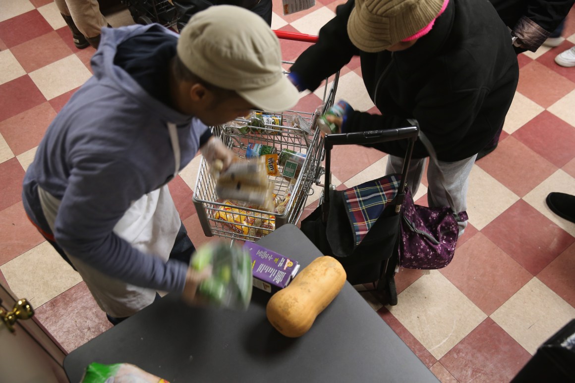 Harlem residents pack free groceries at the Food Bank For New York City on December 11th, 2013, in New York City.