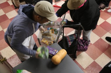 Harlem residents pack free groceries at the Food Bank For New York City on December 11th, 2013, in New York City.