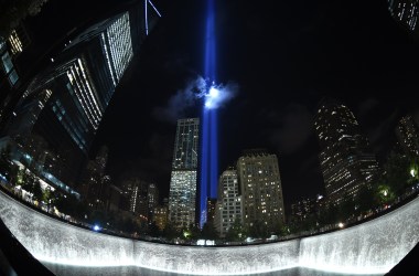 The Tribute in Light illuminates the sky behind the 9/11 Memorial waterfalls and reflecting pool in New York on September 10th, 2014.