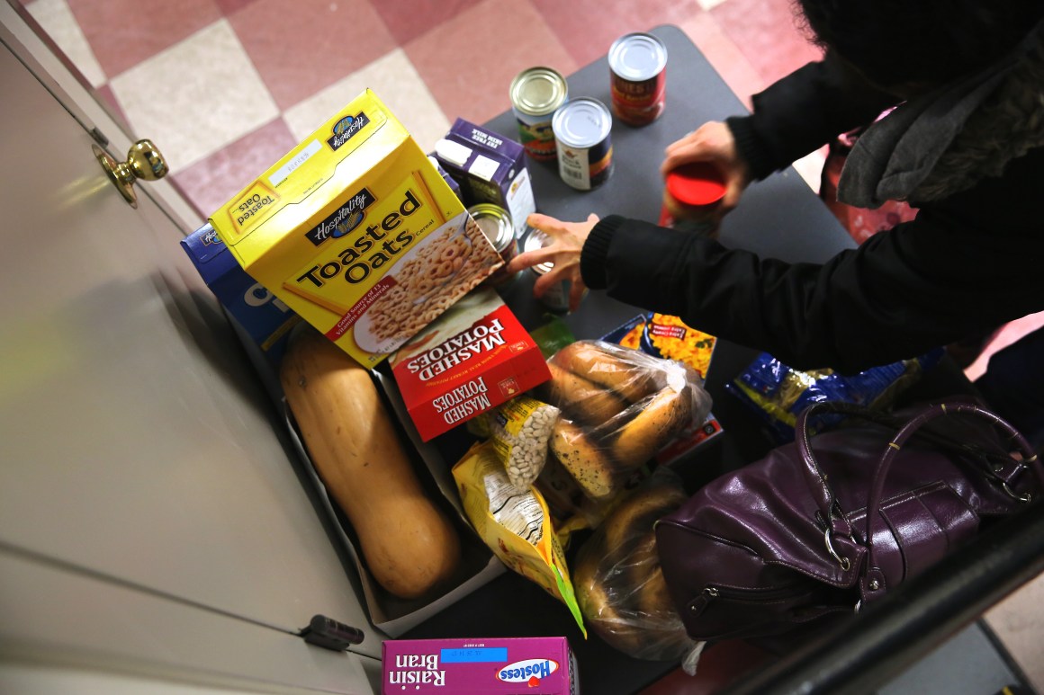 People receive free groceries at a food pantry run by the Food Bank For New York City on December 11th, 2013, in New York City.