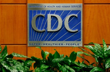 A podium with the logo for the Centers for Disease Control and Prevention.