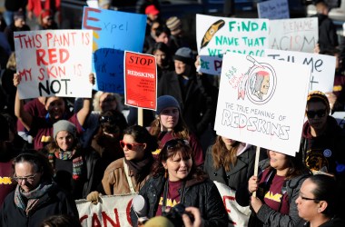 People march in protest against the mascot for the Washington Redskins before the team's game against the Minnesota Vikings on November 2nd, 2014, in Minneapolis, Minnesota. Opponents of the Redskins name say it's a slur that mocks Native American culture and they want the team to change it.