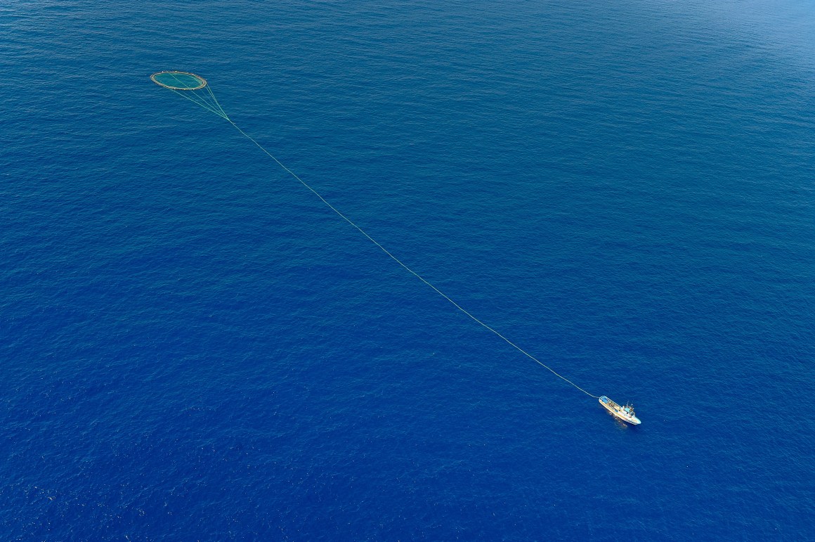 A tuna fishing boat drags a cage of nets on the Mediterranean.